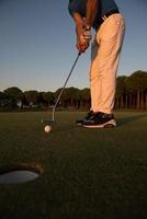 golfer  hitting shot at golf course photo