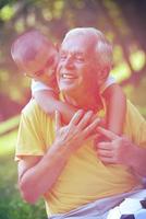 happy grandfather and child in park photo