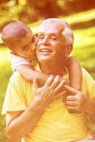 grandfather and child have fun  in park photo