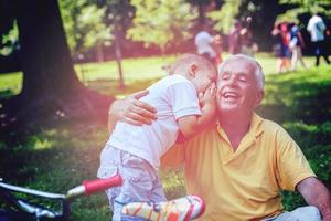 grandfather and child have fun  in park photo