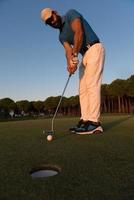 golfer  hitting shot at golf course photo