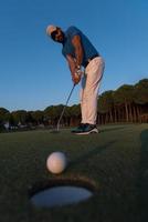 golfer  hitting shot at golf course photo