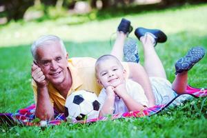 grandfather and child have fun  in park photo