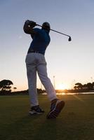 golfer hitting long shot photo