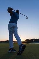 golfer hitting long shot photo