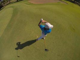 top view of golf player hitting shot photo