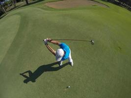 top view of golf player hitting shot photo