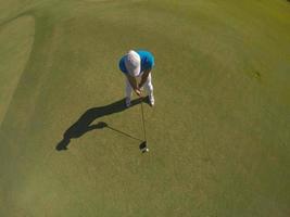 top view of golf player hitting shot photo