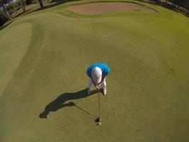 top view of golf player hitting shot photo