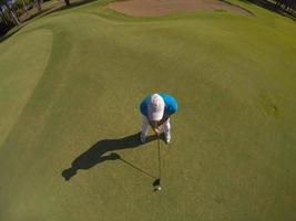 top view of golf player hitting shot photo