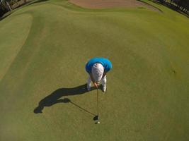 top view of golf player hitting shot photo