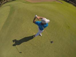 top view of golf player hitting shot photo