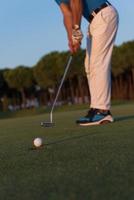 golfer  hitting shot at golf course photo