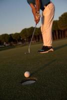 golfer  hitting shot at golf course photo