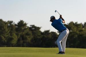 golfer hitting long shot photo