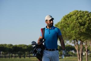 golfer  walking and carrying bag photo