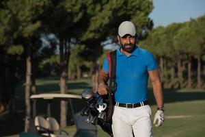 golfer  walking and carrying golf  bag photo