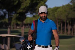 golfer  walking and carrying golf  bag photo