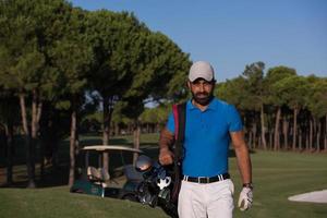 golfer  walking and carrying golf  bag photo