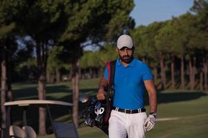 golfer  walking and carrying golf  bag photo