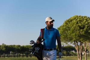 golfer  walking and carrying bag photo