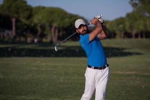 pro golfer hitting a sand bunker shot photo