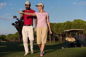 couple walking on golf course photo