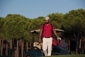 golfer  walking and carrying golf  bag photo