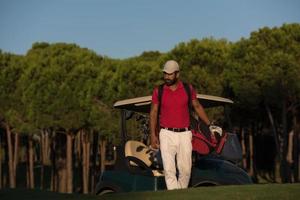 golfer  walking and carrying golf  bag photo