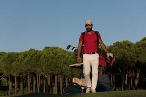 golfer  walking and carrying golf  bag photo