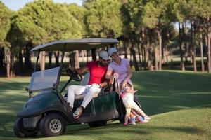 couple in buggy on golf course photo