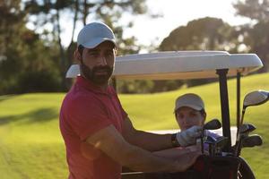 couple in buggy on golf course photo