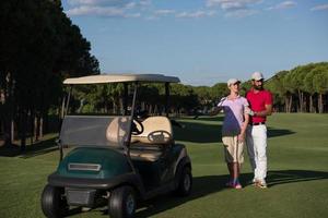 couple in buggy on golf course photo