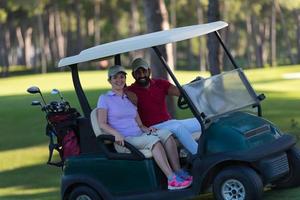 couple in buggy on golf course photo