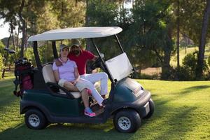 couple in buggy on golf course photo