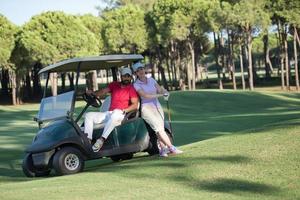 couple in buggy on golf course photo