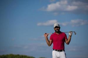 handsome middle eastern golf player portrait at course photo