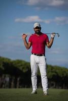 handsome middle eastern golf player portrait at course photo