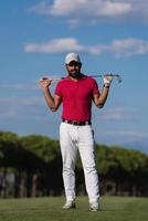 handsome middle eastern golf player portrait at course photo