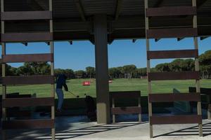 golf player practicing shot on training photo