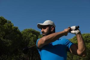 golf player hitting shot photo