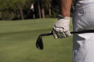 golf player close up hand and driver from back photo