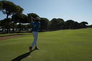 golf player hitting shot photo