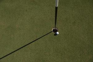 top view of golf ball in the hole photo