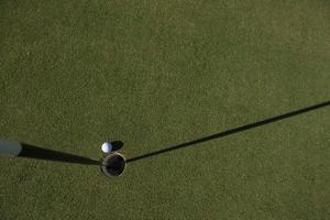 top view of golf ball in the hole photo