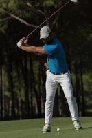 golf player hitting shot photo