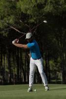 golf player hitting shot photo