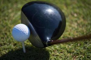 top view of golf club and ball in grass photo