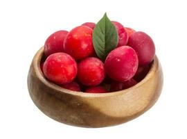 Damson plum in a bowl on white background photo