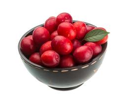 Damson plum in a bowl on white background photo